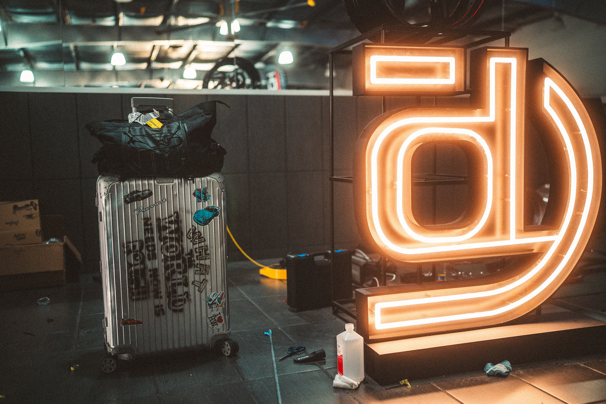 Neon sign with a large letter 'd' in a dimly lit room.