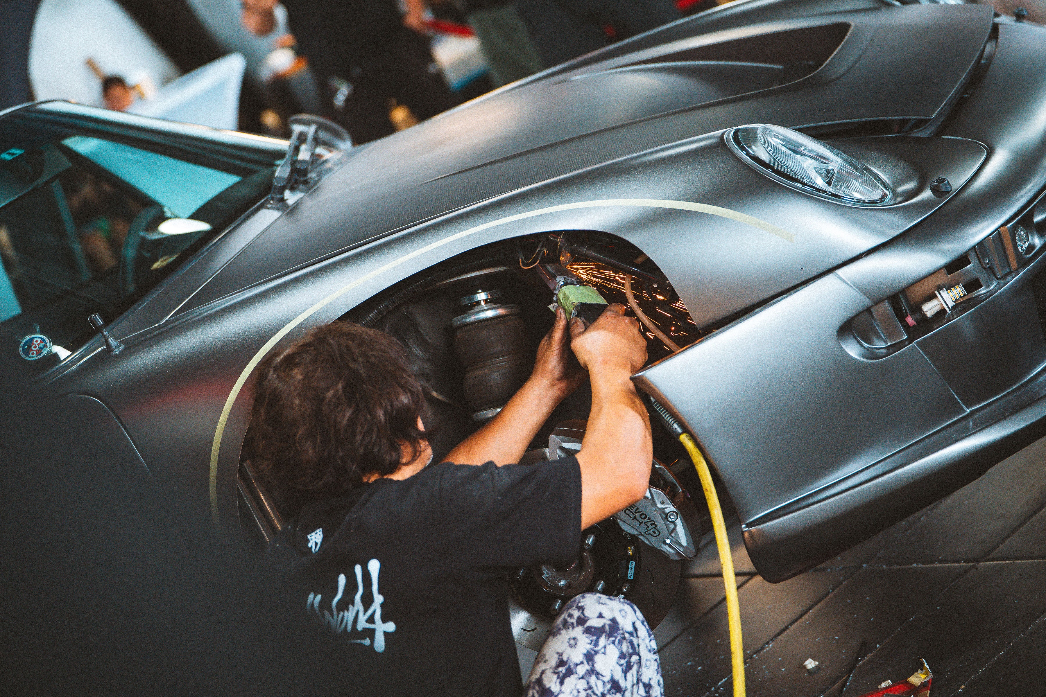 Person working on a car in a garage