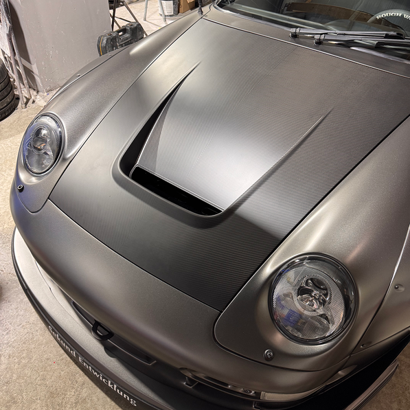 Gray sports car in a garage setting