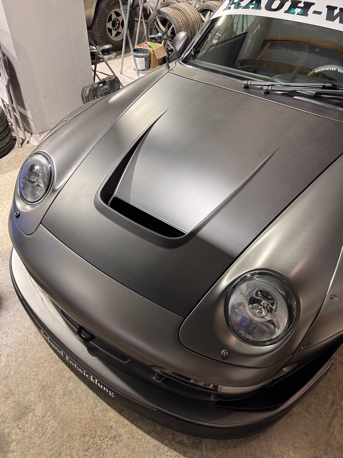 Gray sports car in a garage setting
