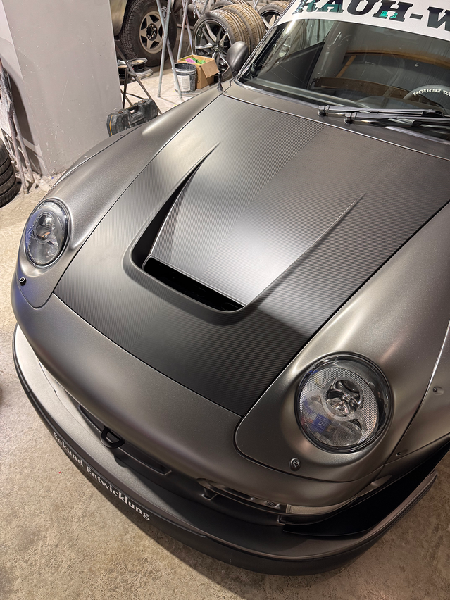 Gray sports car in a garage setting