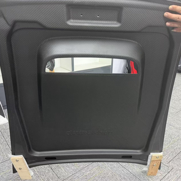 Car hood cover on wooden blocks with a blurred background