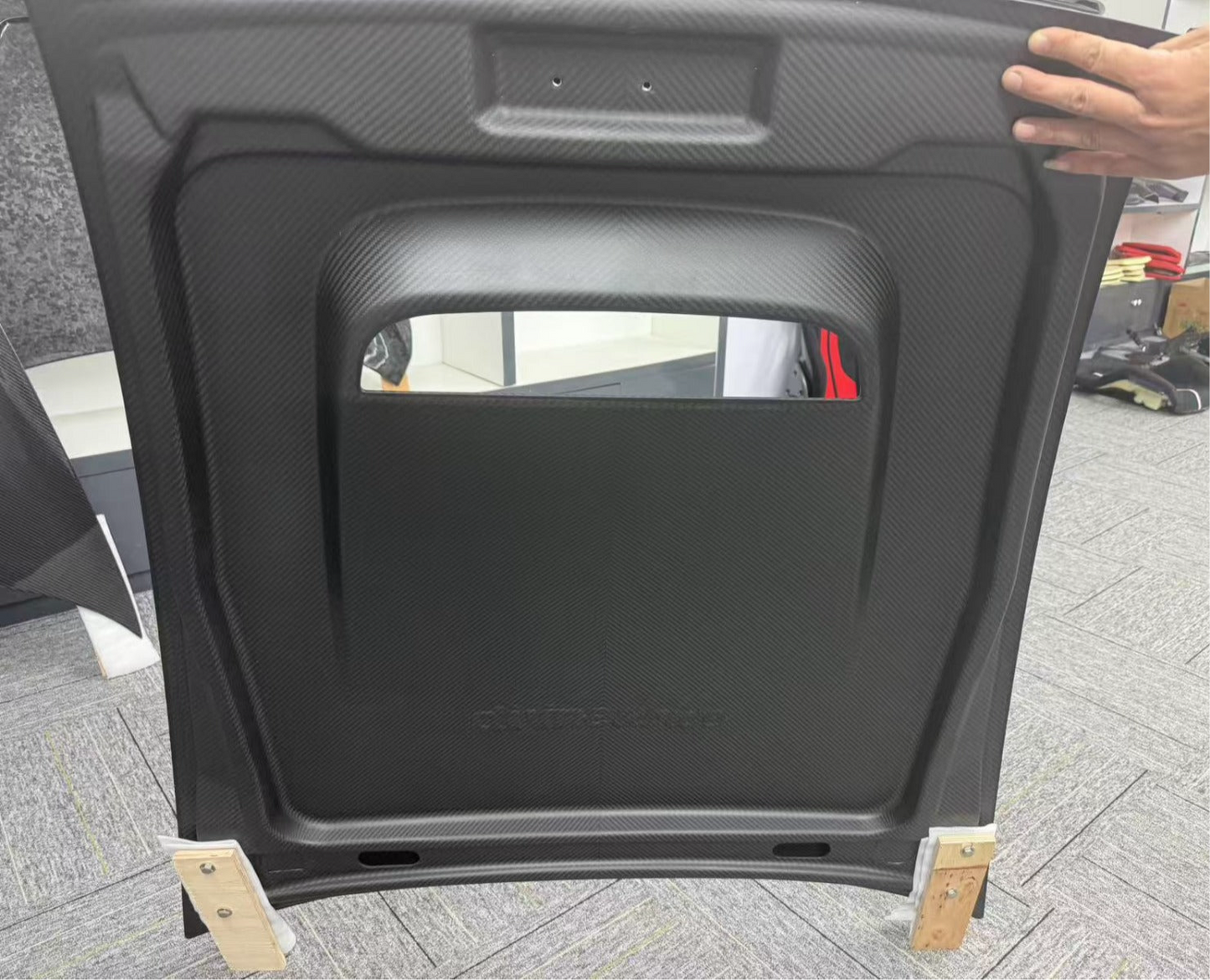 Car hood cover on wooden blocks with a blurred background