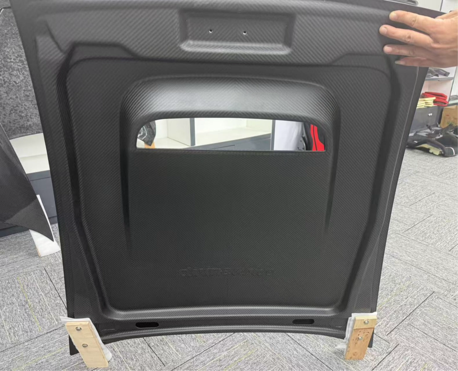 Car hood cover on wooden blocks with a blurred background