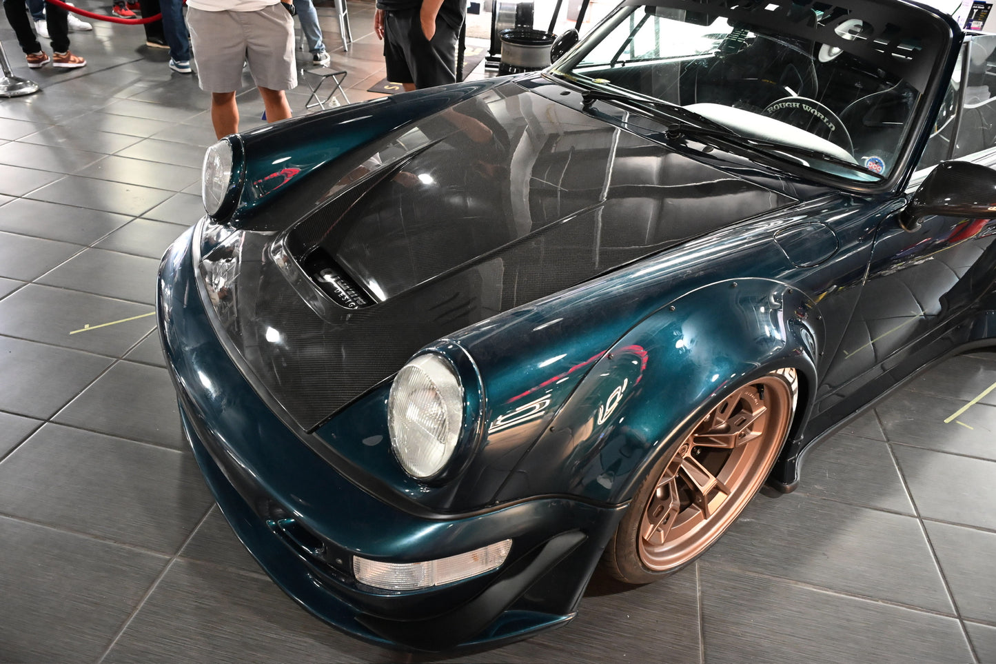 Luxury car with bronze rims on a tiled floor