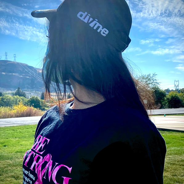 Woman wearing Divine Designs hat