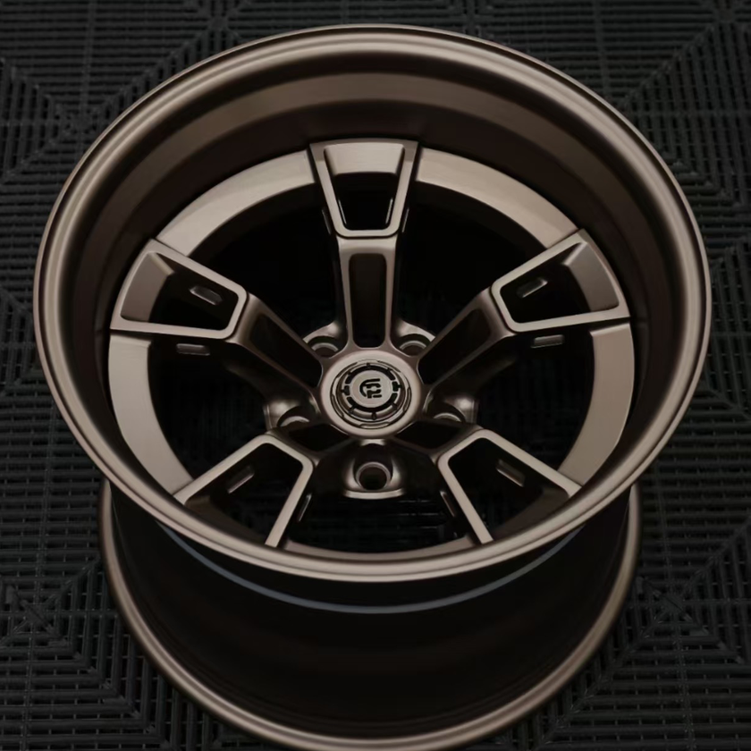 Close-up of a metallic car wheel rim on a dark textured background