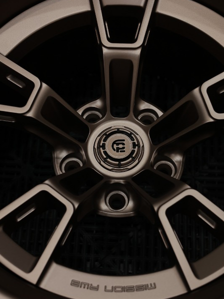 Close-up of a car wheel rim with a brand logo