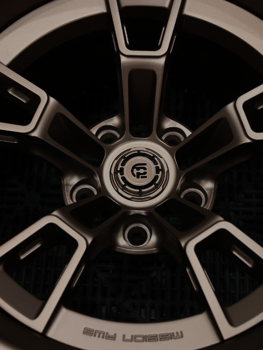 Close-up of a car wheel rim with a brand logo