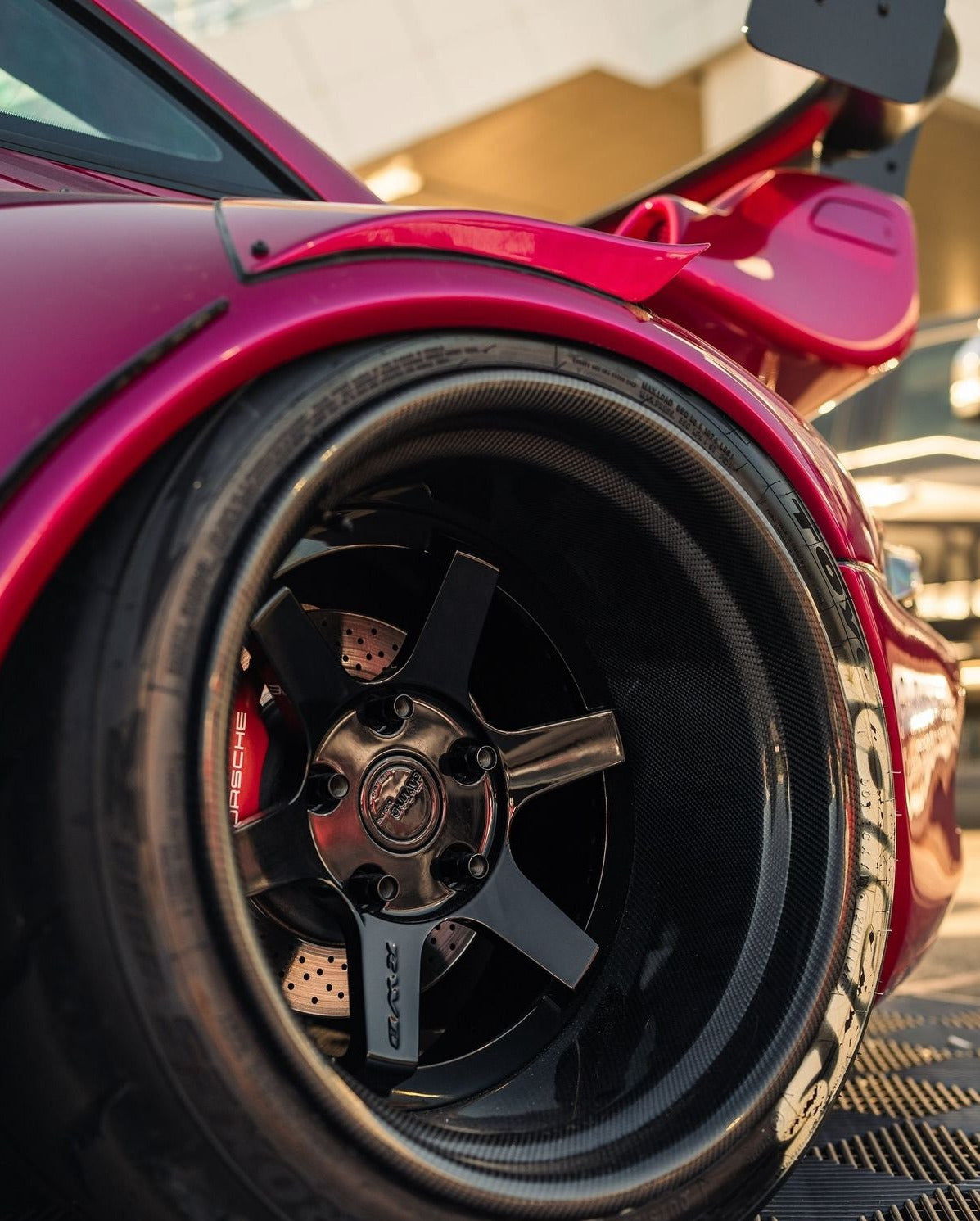 Close-up of a red car wheel with a visible logo.