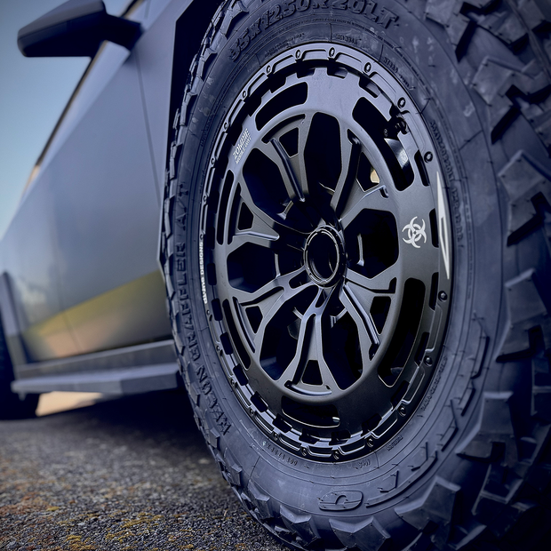 Close-up of a car tire with a detailed tread pattern on a road.