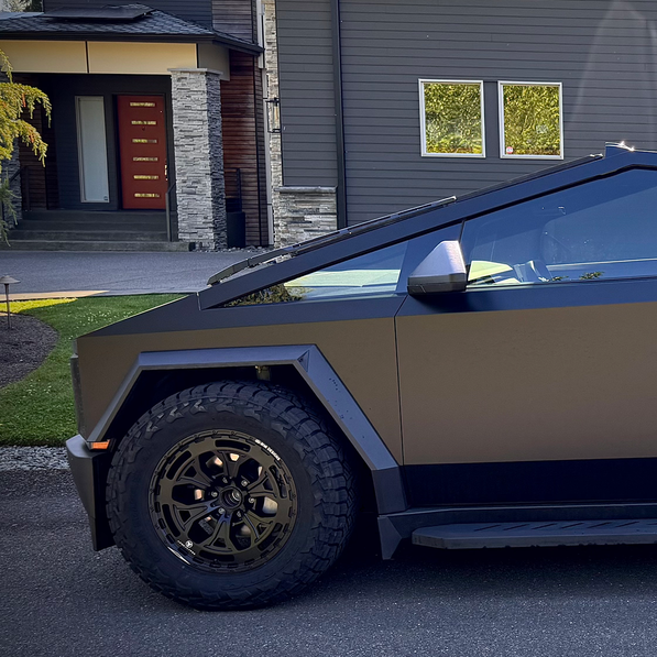 Car with custom wheels parked in front of a house