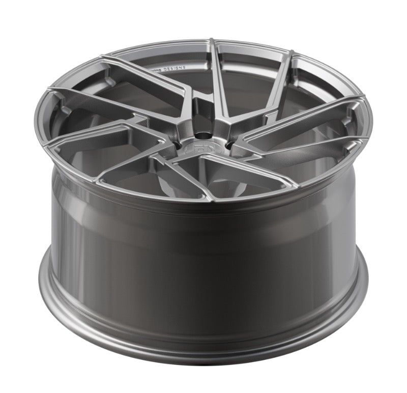 Metallic gray alloy wheel on a white background