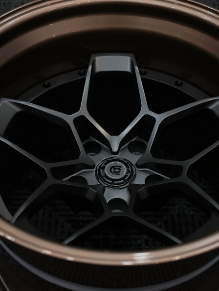 Close-up of a black wheel with a detailed design