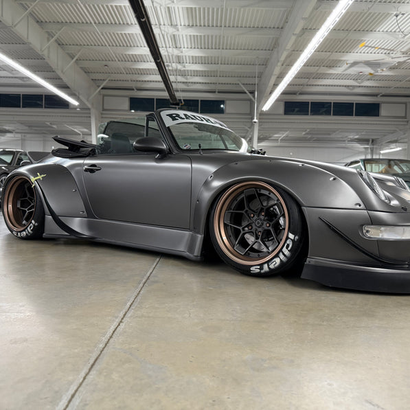 Silver sports car with custom modifications in a garage