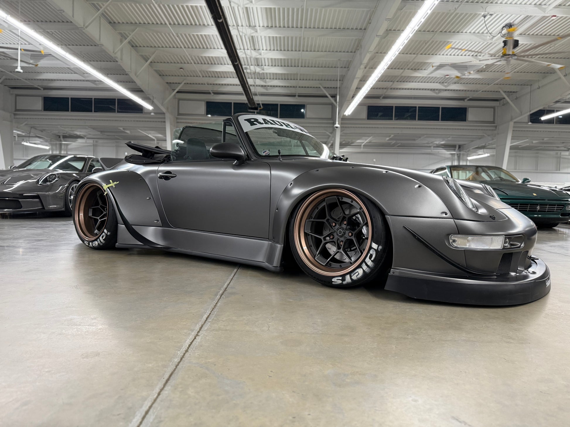 Silver sports car with custom modifications in a garage