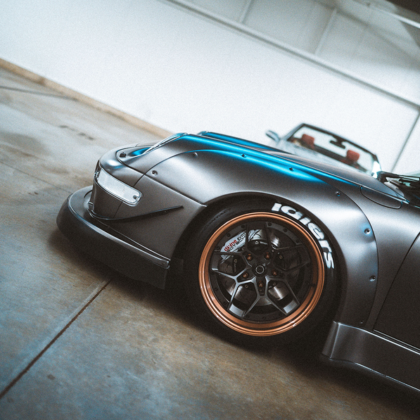 Silver sports car with a custom wheels in a garage