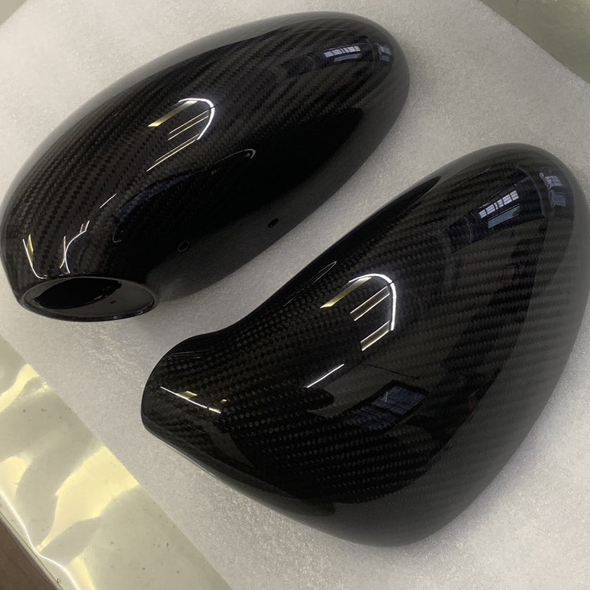 Close-up image of a one-piece seamless carbon fiber aero mirror for Porsche vehicles