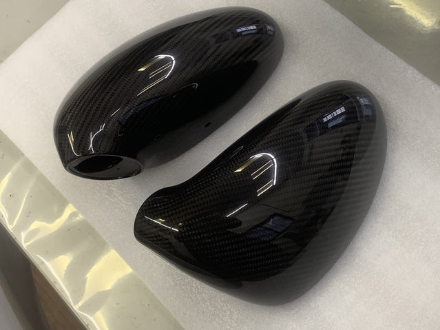 Close-up image of a one-piece seamless carbon fiber aero mirror for Porsche vehicles