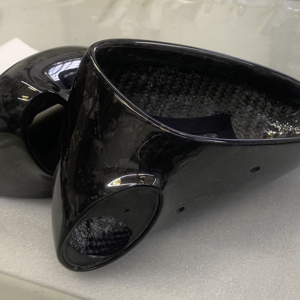 Close-up image of a one-piece seamless carbon fiber aero mirror for Porsche vehicles