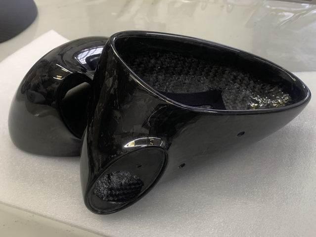 Close-up image of a one-piece seamless carbon fiber aero mirror for Porsche vehicles
