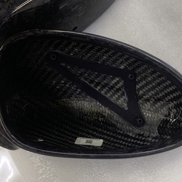 Close-up image of a one-piece seamless carbon fiber aero mirror for Porsche vehicles
