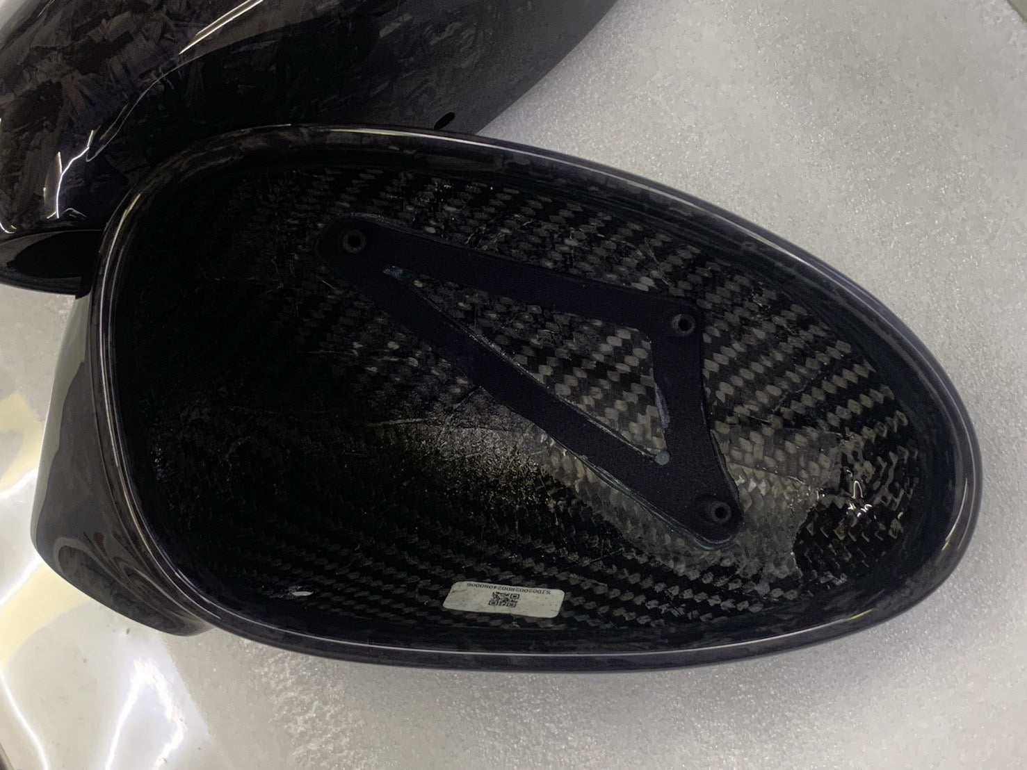 Close-up image of a one-piece seamless carbon fiber aero mirror for Porsche vehicles