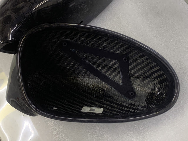 Close-up image of a one-piece seamless carbon fiber aero mirror for Porsche vehicles