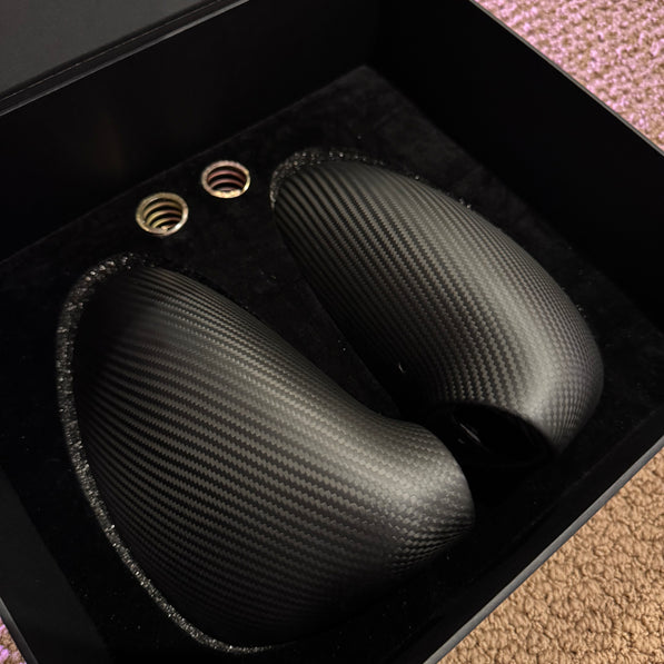 Close-up image of a one-piece seamless carbon fiber aero mirror for Porsche vehicles