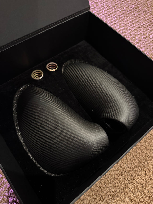 Close-up image of a one-piece seamless carbon fiber aero mirror for Porsche vehicles