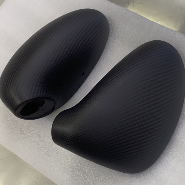 Close-up image of a one-piece seamless carbon fiber aero mirror for Porsche vehicles