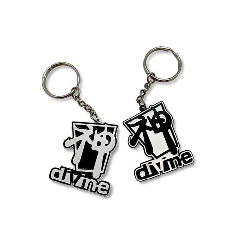 Two black and white metal keychains with the word 'DIVINE' inscribed on them.
